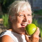 A person biting into an apple