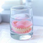 Dentures soaking in glass