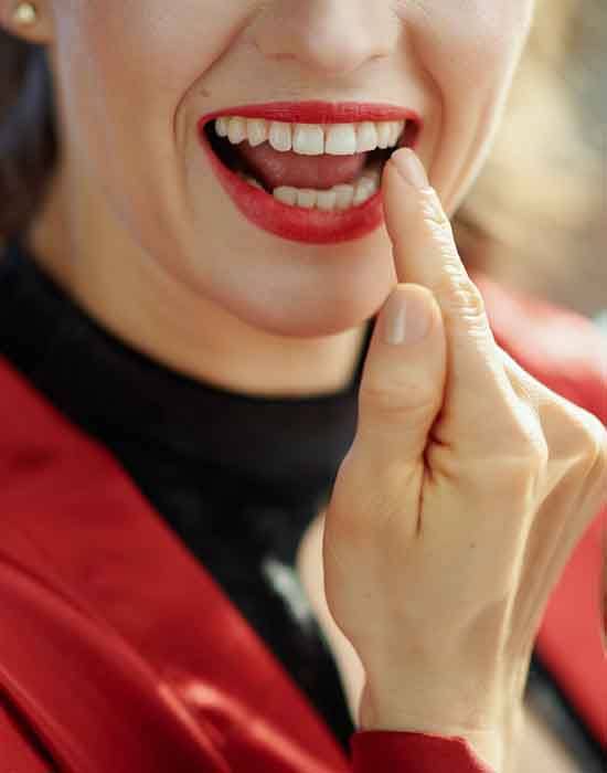 Woman pointing to her tooth