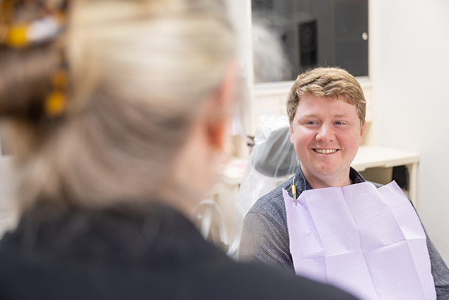 Woman smiling at dentist during dental exam